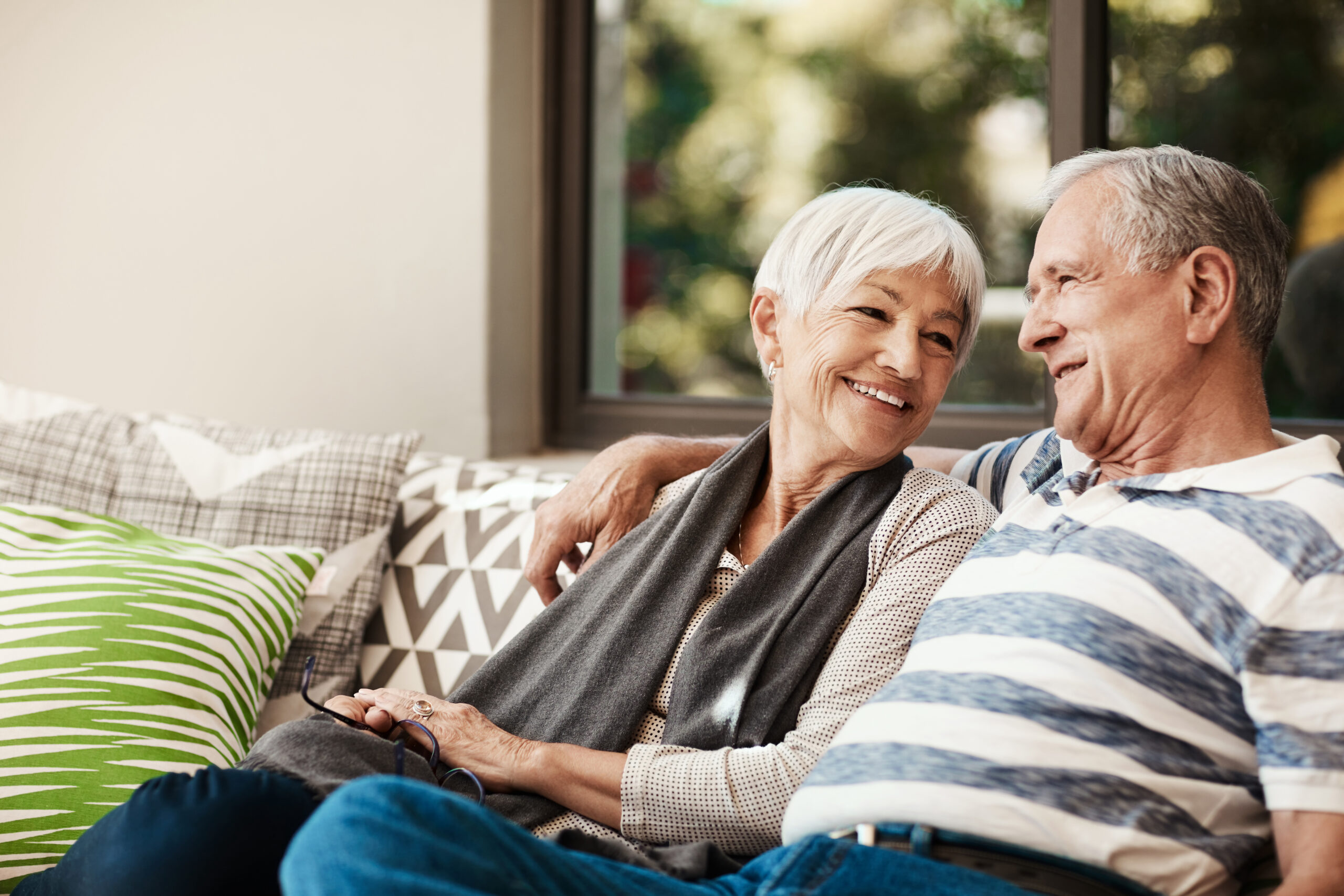 Shot of a happy senior couple relaxing together on a sofa outside at home